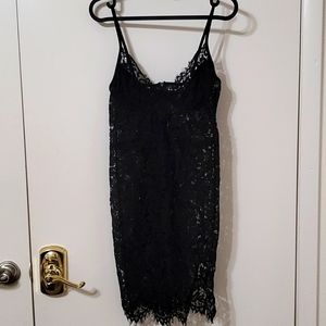 Black lace dress. Adjustable straps and little cut on left leg.